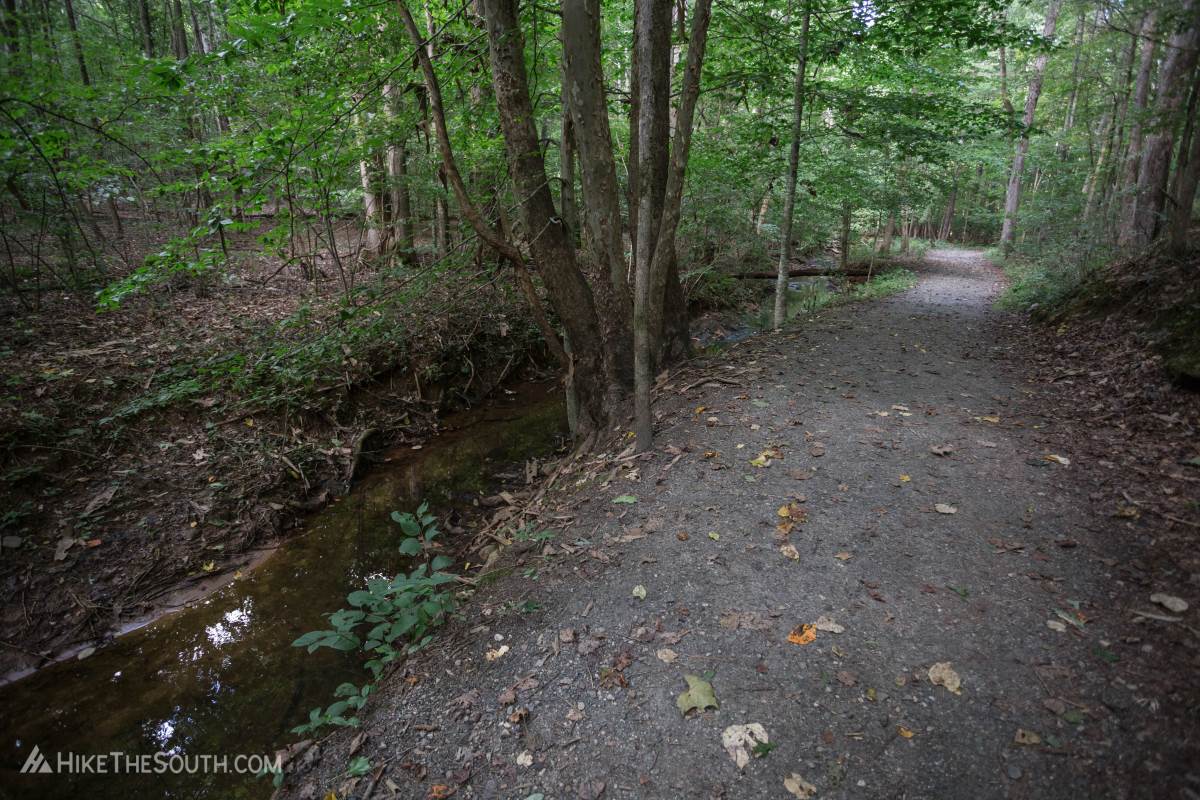 Little Mulberry Ravine, Woodland, and Beech Tree Loop. 
A little less than half a mile of the Ravine Loop is unpaved, following along the creek.