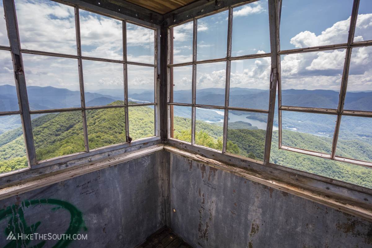 Shuckstack Fire Tower. 
View from inside the room at the top of the tower. The boards here are a in a little rougher shape but not dangerous. Yet.